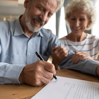Close,Up,Satisfied,Older,Couple,Signing,Documents,,Making,Purchasing,Or Close,Up,Satisfied,Older,Couple,Signing,Documents,,Making,Purchasing,Or